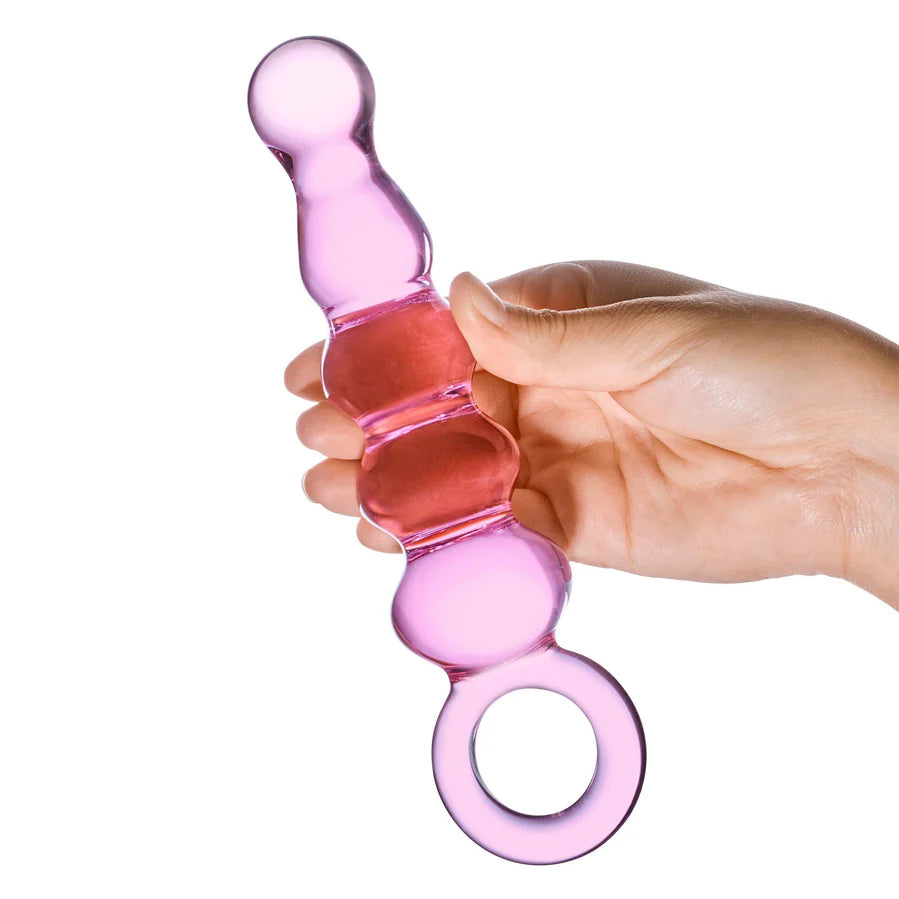 A hand holds the Glas Quintessence. The dildo looks decently thick in their hands but not overwhelmingly so. It looks about the size of an average penis. | Kinkly Shop