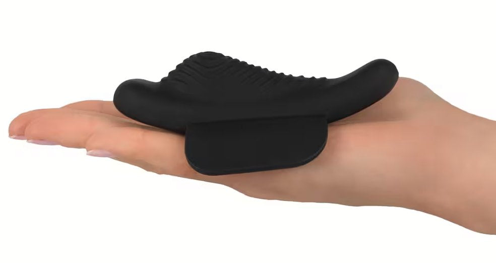 The GoGasm Panty Vibrator laid out on a person's flat palm. The toy has hills and ridges within it, designed to best hit the clitoris and pleasure the surrounding vulva. | Kinkly Shop