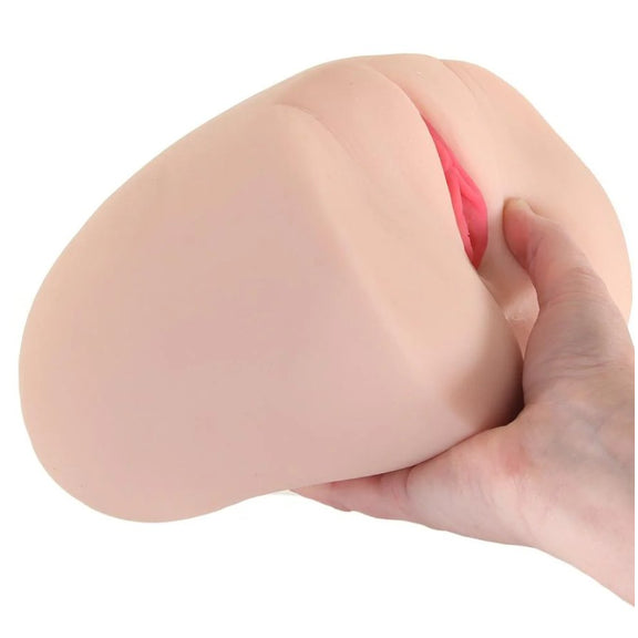A hand holds the Keisha Grey Titwoman: Double Sided Masturbator up. It's much larger than the stroker, but the stroker can be held up with a single hand. | Kinkly Shop
