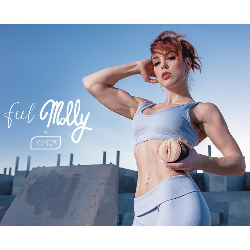 Molly Stewart is in athletic clothing looking extremely strong while looking into the camera. They're holding the FeelStars FeelMolly Stroker | Kinkly Shop