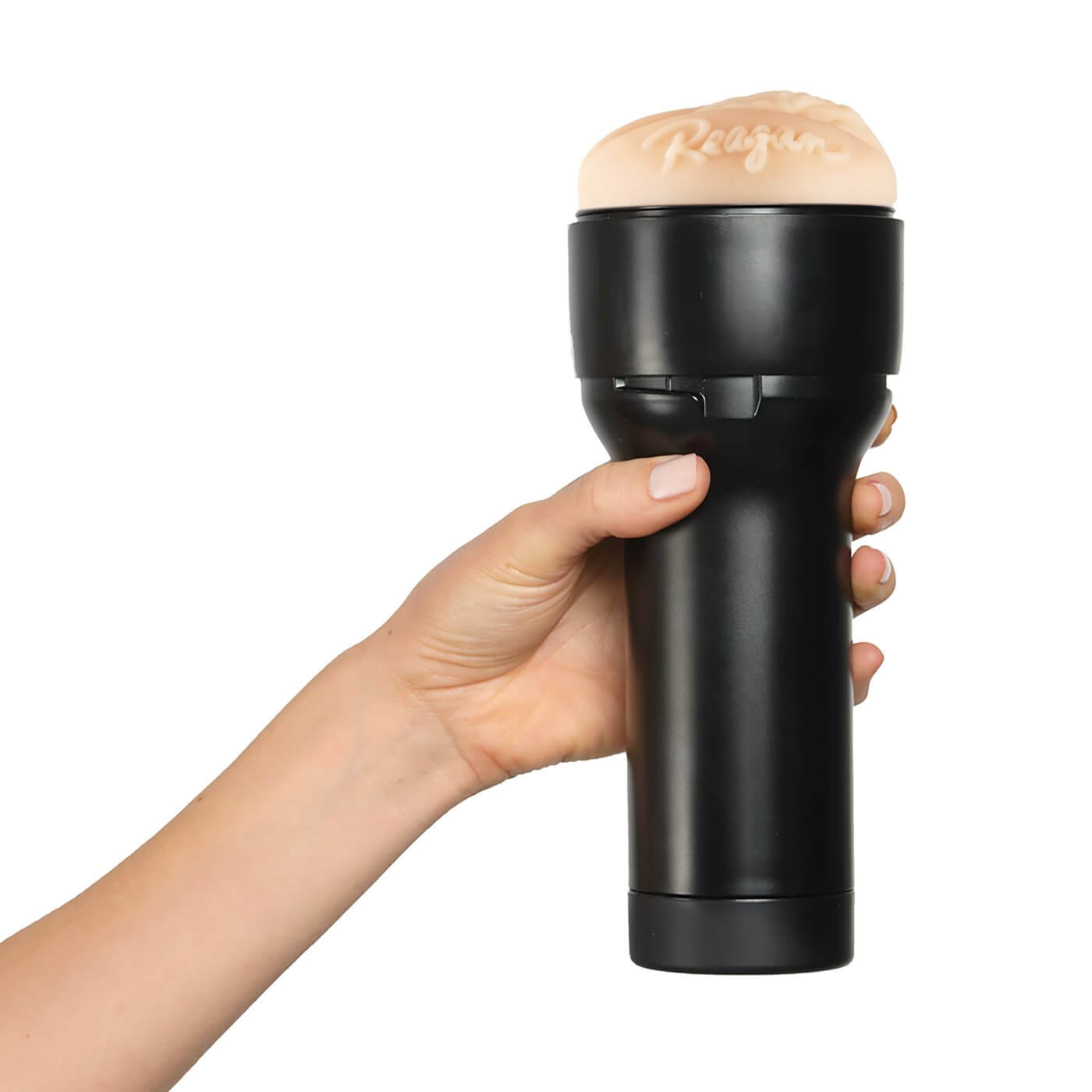 A hand holds the KIIROO FeelStars FeelReagan Stroker. The hand wraps comfortably around the handle of the stroker. | Kinkly Shop