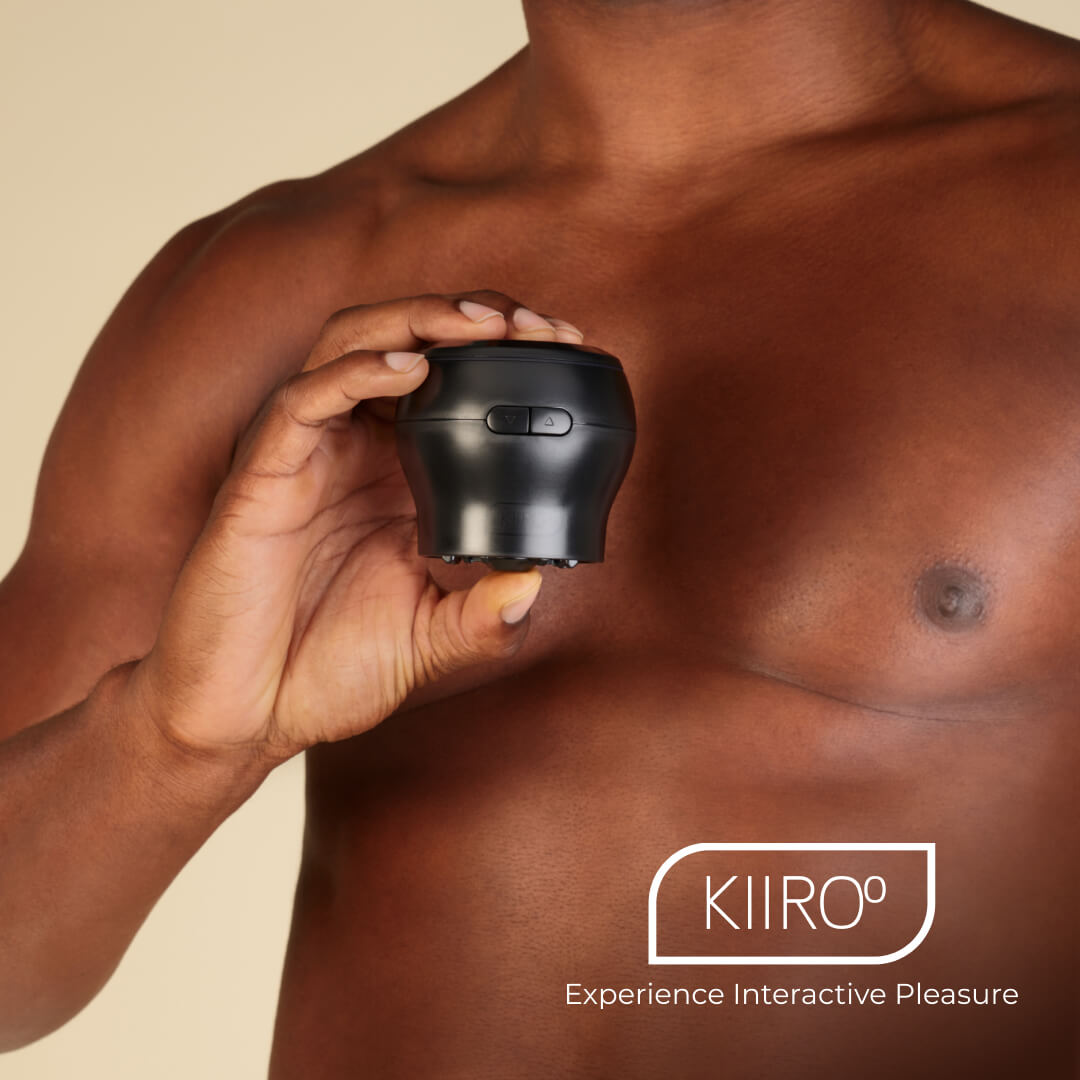 A person holds the KIIROO Power Blow in their hand. They're bare-chested. It's surprisingly slender, and it looks like the Power Blow attachment itself would fit in the palm of their hand. | Kinkly Shop