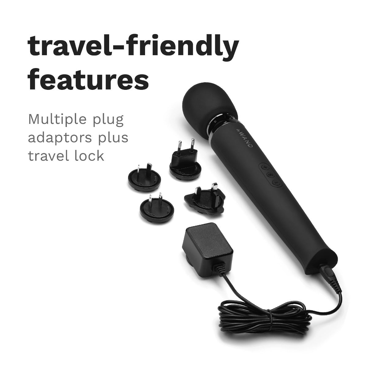 The Le Wand Rechargeable Wand in Black is sitting out next to the charger and its converter plates. Text on the image reads: "travel-friendly features. Multiple plug adaptors plus travel lock." | Kinkly Shop
