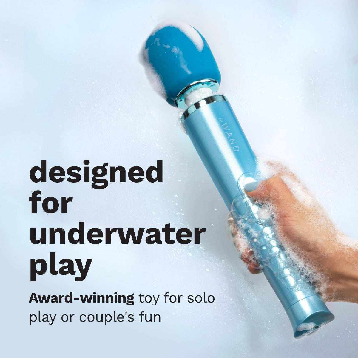 A hand holds the in the water as it's covered in suds and dripping wet. Text reads: "Designed for underwater play. Award-winning toy for solo play or couple's fun. | Kinkly Shop