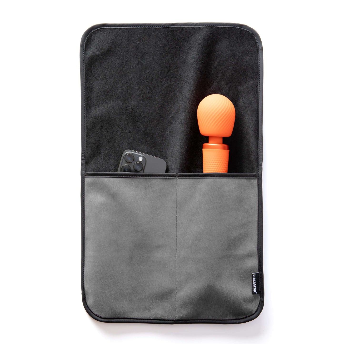 The Liberator Fascinator Sex Toy Caddy in Grey laying flat on a white surface. A wand massager and a cell phone are shown peeking out from the tops of the pockets. The full length of the wand massager fits within the deep pocket, leaving only the massager's head showing from the pocket. | Kinkly Shop