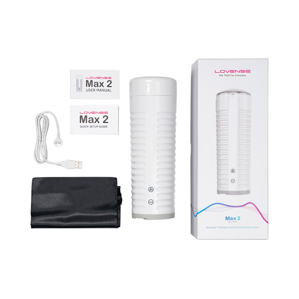 Everything that's included with the Lovense Max 2. There's the stroker itself, the stroker lid, the user manual, the quick set-up guide, the charging cable, and the black drawstring storage bag. | Kinkly Shop