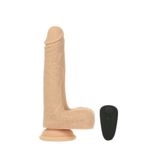 The Freak 7.5": Rotating, Thrusting, and Vibrating in front of a plain white background shown next to the wireless remote | Kinkly Shop