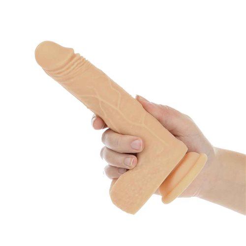 A hand holds the The Freak 7.5": Rotating, Thrusting, and Vibrating. The dildo looks somewhat realistic and has a slimmer design. | Kinkly Shop