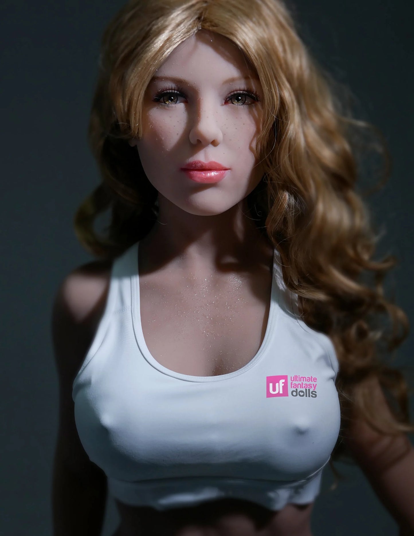 The Ultimate Fantasy Doll: Mandy looks seductively into the camera while wearing a white, see-through crop top that her nipples can be seen through. | Kinkly Shop