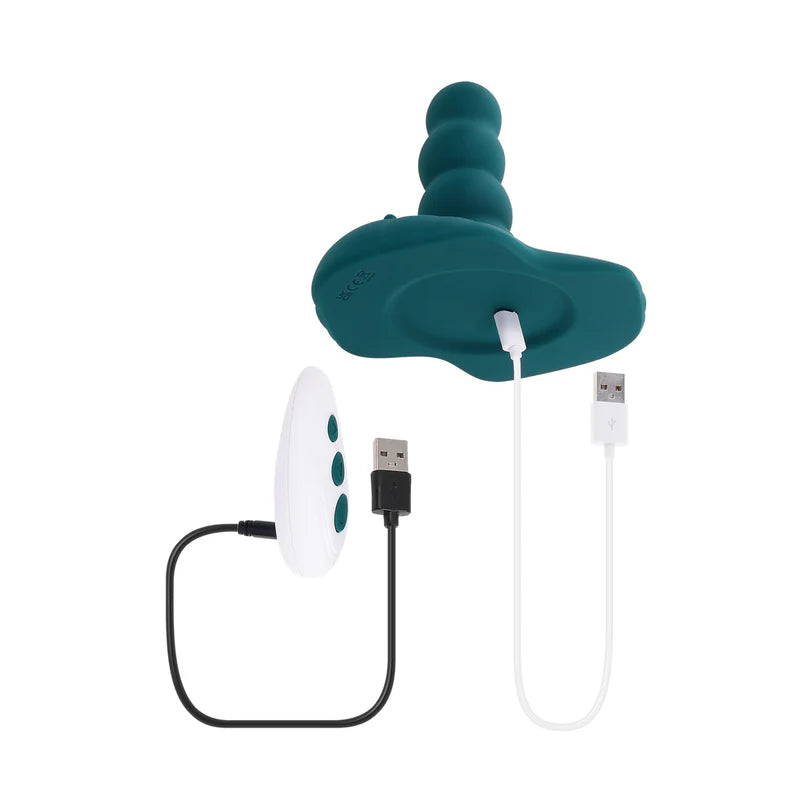 The Playboy Have A Seat toy and the remote control next to one another. Both of them are plugged into their charging cables, showcasing their rechargeability. | Kinkly