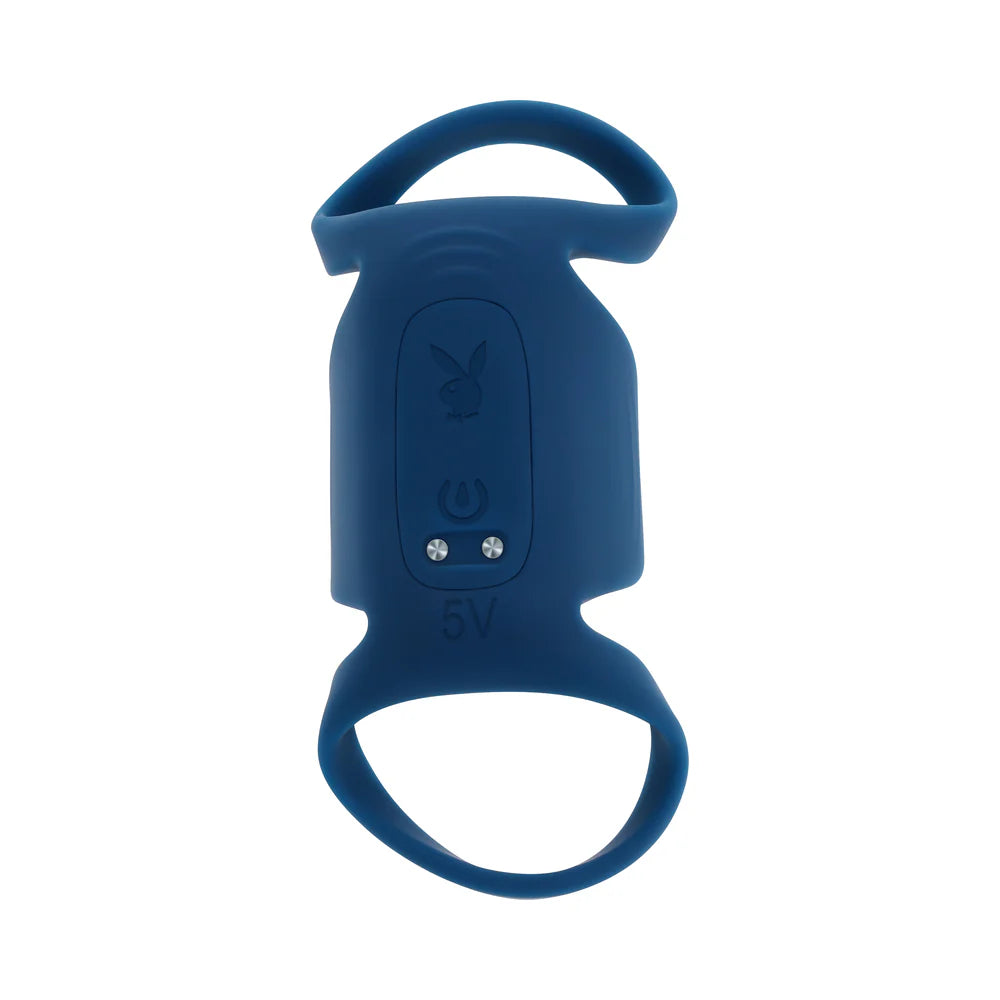 Close-up on the external side of the Playboy Jet Pack that faces away from the shaft itself when the toy is worn. The button to control the vibrator is here as well as a Playboy logo. There's also two magnetic points that function as the charger contact points. | Kinkly Shop