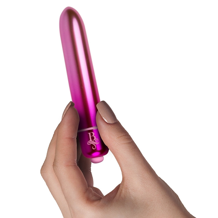 A person holds the Boudoir Courtesan vibe in-between two fingers. The vibrator looks about the length and thickness of a person's one finger. | Kinkly