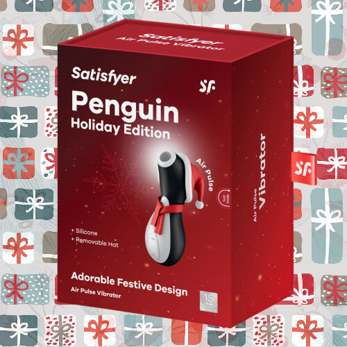 Packaging for the Satifyer Pro Penguin Holiday Edition in front of a holiday gifting wallpaper. The box is a bright red that looks perfect for the holidays. | Kinkly Shop