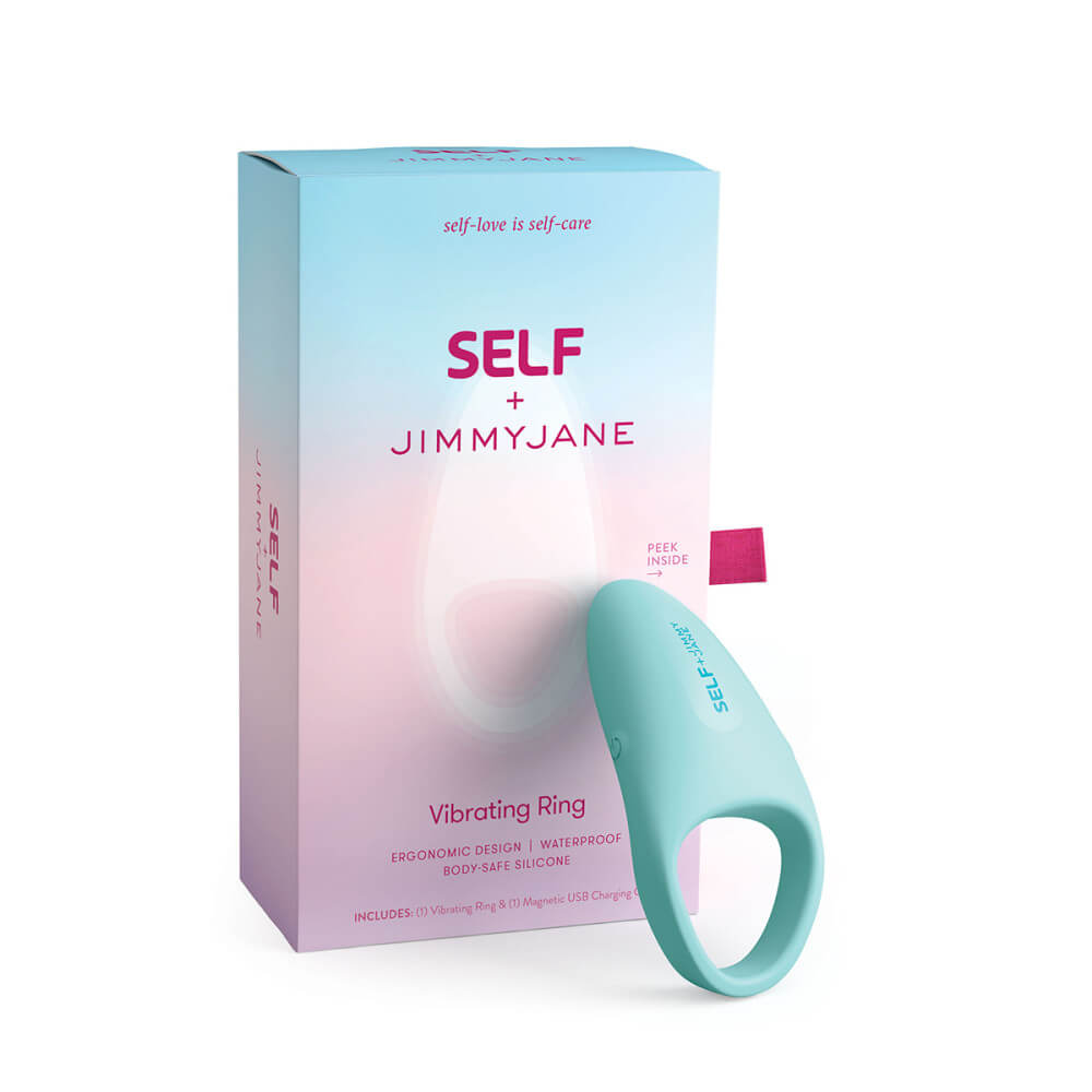 The SELF + Jimmyjane Vibrating C-Ring resting up against the packaging that the cock ring comes in. | Kinkly Shop