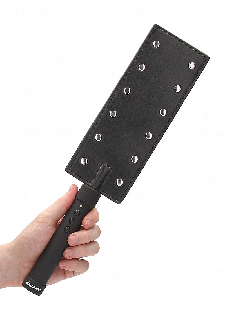 A hand holds the ElectroShock Rechargeable Paddle in their hand. The paddle has 12 contact probes for the estimulation. | Kinkly Shop