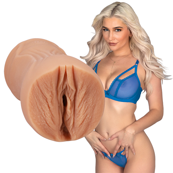 Skye is standing next to the Signature Strokers - Skye Blue, looking into the camera. The entrance of the stroker is directly molded from Skye's own vulva. | Kinkly Shop