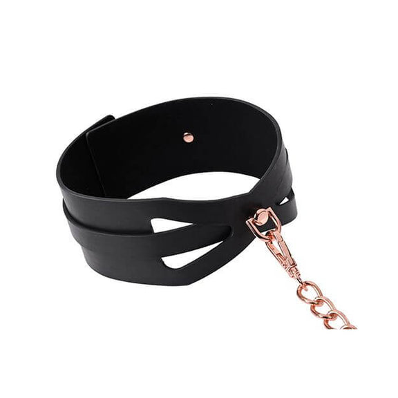 Close-up of the D-ring where the leash attaches to the collar in the Sportsheets Brat Collar and Leash. A single rivet can be seen on the inner lining of the Sportsheets Brat Collar. The area with the D-ring attachment point is the thinnest in height compared to the rest of the collar. | Kinkly Shop