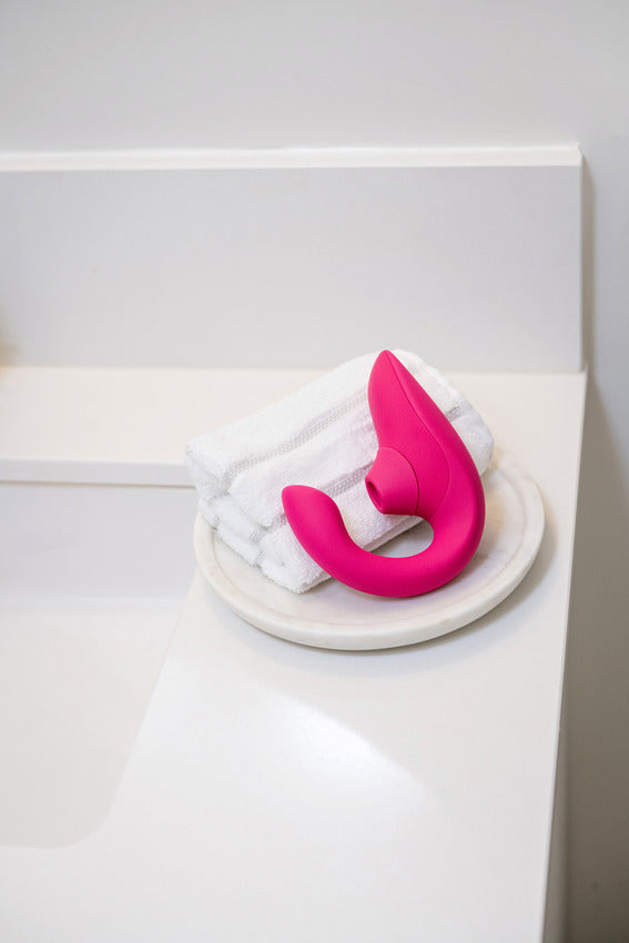 The Womanizer Blend laying next to the sink. It's about the size of a quartered up folded washcloth. | Kinkly