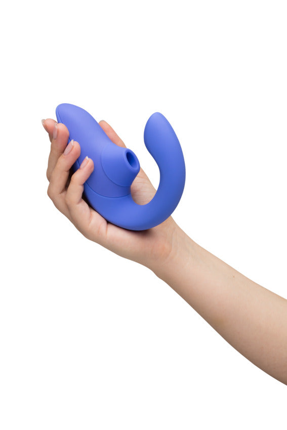 A hand holds the Womanizer Blend. The toy looks small and lightweight, and it easily curls up in the person's palm in a single hand. | Kinkly