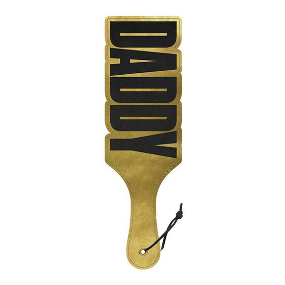 Front side of the Wood Rocket Daddy Paddle. The paddle is a shiny, shimmery gold except for the words "DADDY" which are written in large, bold letters throughout the entire paddle. | Kinkly Shop