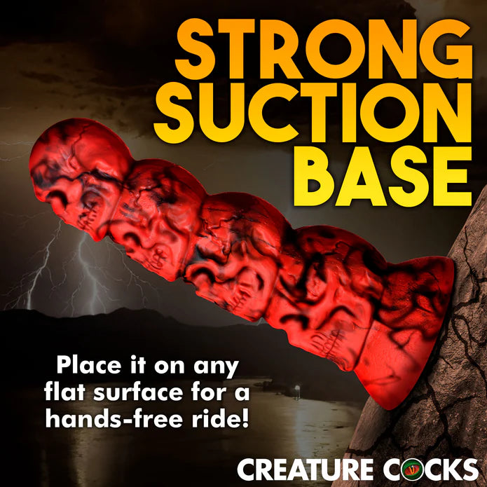 The Creature Cocks Doom shown adhered to a cracked boulder. Text on the image reads: Strong suction base. Place it on any flat surface for a hands-free ride. | Kinkly Shop