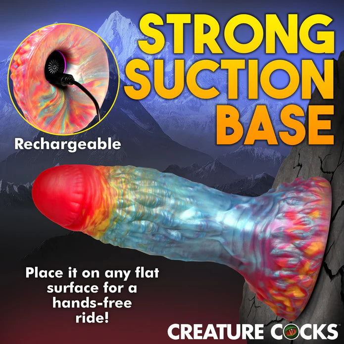 The base of the Creature Cocks Phoenix Vibrating Remote-Control Dildo is stuck up against a flat vertical surface. Text on the image reads: "Rechargeable. Strong suction base. Place it on any flat surface for a hands-free ride." | Kinkly Shop