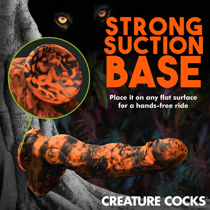 The Creature Cocks Sabertooth is shown suction cupped to a vertical surface. Text on the image reads: "Strong suction base. Place it on any flat surface for a hands-free ride" | Kinkly Shop