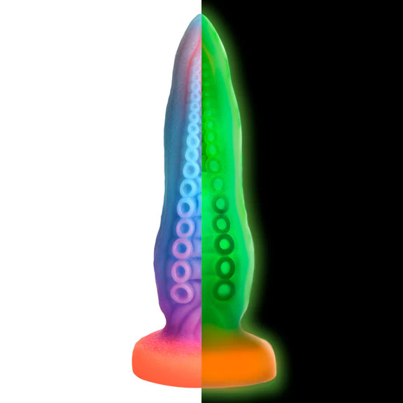 Two images of the Creature Cocks Tenta-Cock shown side-by-side, with the daylight view of the dildo on the left and the glow-in-the-dark view of the dildo on the right. | Kinkly Shop