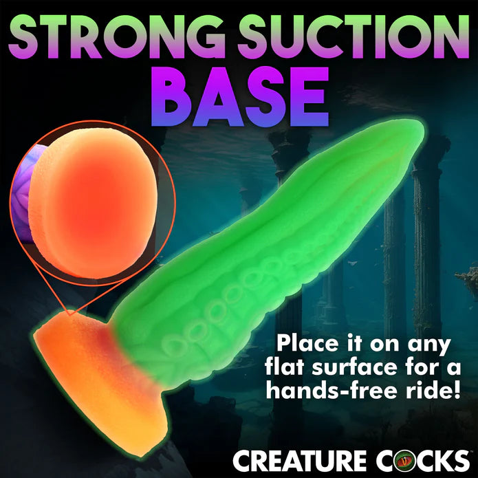 The Creature Cocks Tenta-Cock shown adhered to a flat surface. Text on the image reads: "Strong suction base. Place it on any surface for a hands-free ride" | Kinkly Shop
