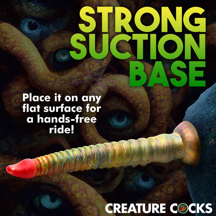 The Creature Cocks Tenta-Dick shown suction cupped to a rock. No idea why. It would not suction cup to a rock. Text on the image reads "Strong suction base. Place it on any flat surface for a hands-free ride!" | Kinkly Shop