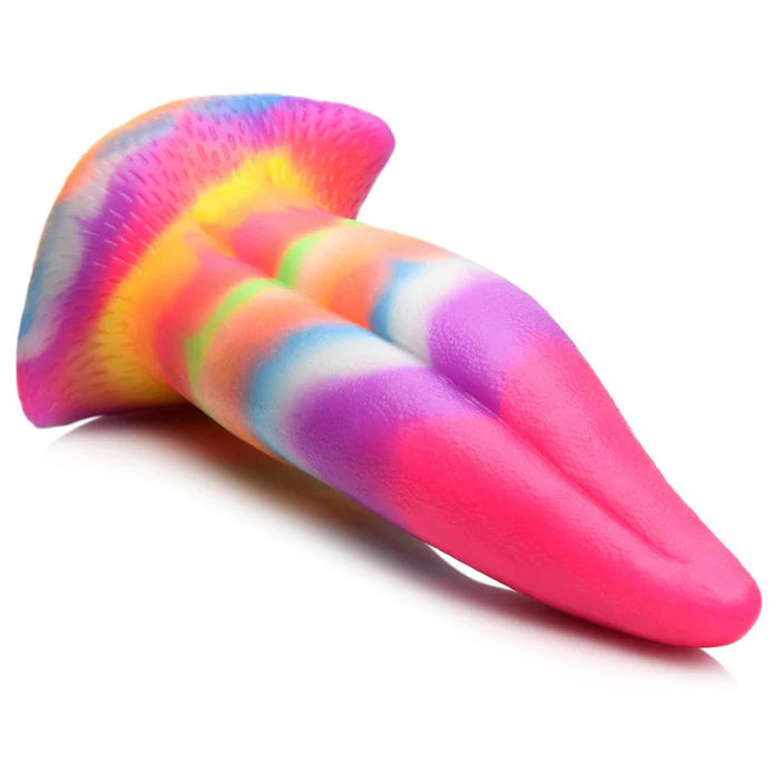 The Creature Cocks Unicorn Kiss lays flat on a surface. The "tongue" looks extremely smooth while the base of the dildo has some light texturing to it. | Kinkly Shop