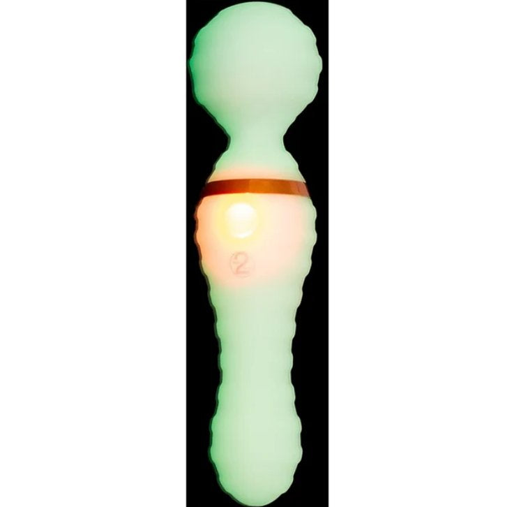 The You2Toys Glow-in-the-Dark Wand Vibrator shown in the dark, glowing, with its glow-in-the-dark functionality. It looks green with an orange light lighting up the single button on the wand massager. | Kinkly Shop