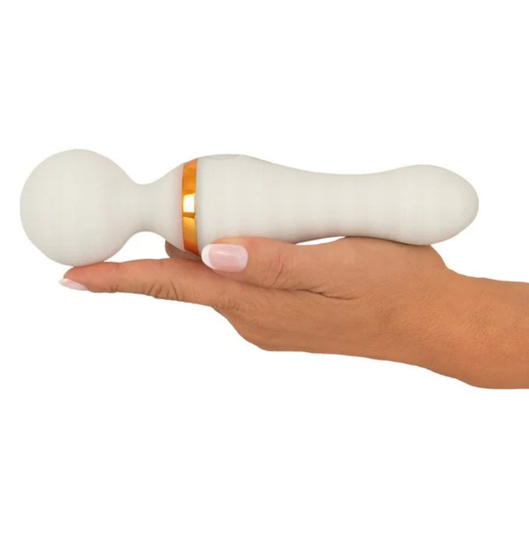 A hand is lying flat, showcasing how long the massager is. The You2Toys Glow-in-the-Dark Wand Vibrator is longer than the person's outstretched hand by a little less than an inch. | Kinkly Shop