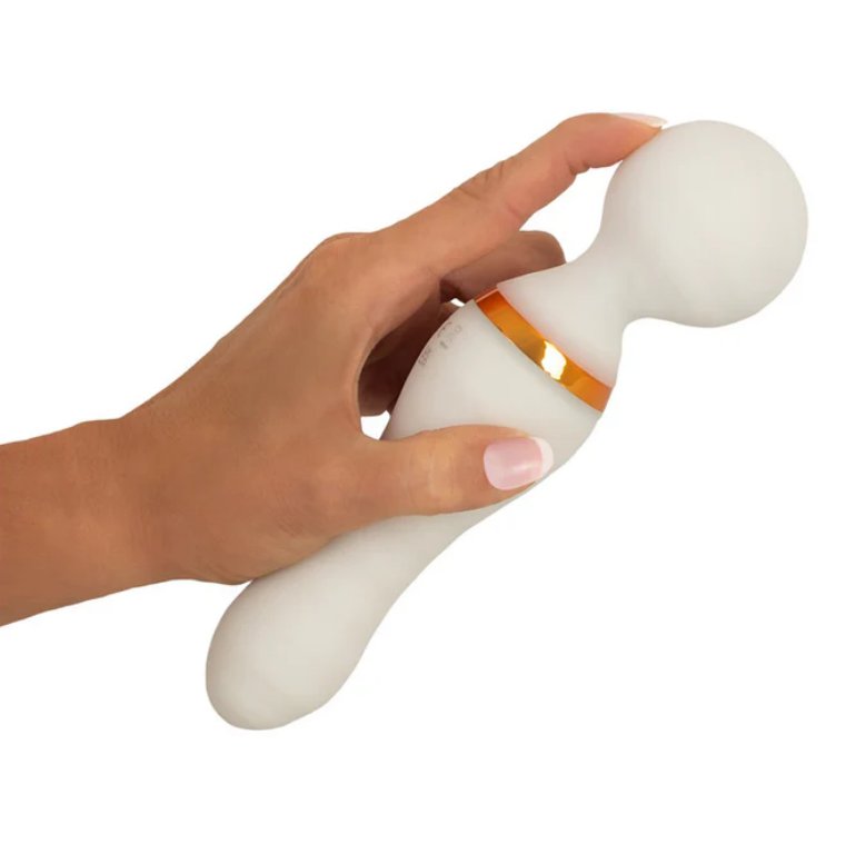 A person is holding the You2Toys Glow-in-the-Dark Wand Vibrator. They're using their pointer finger to try to bend the head of the massager. It bends a little under the pressure. | Kinkly Shop