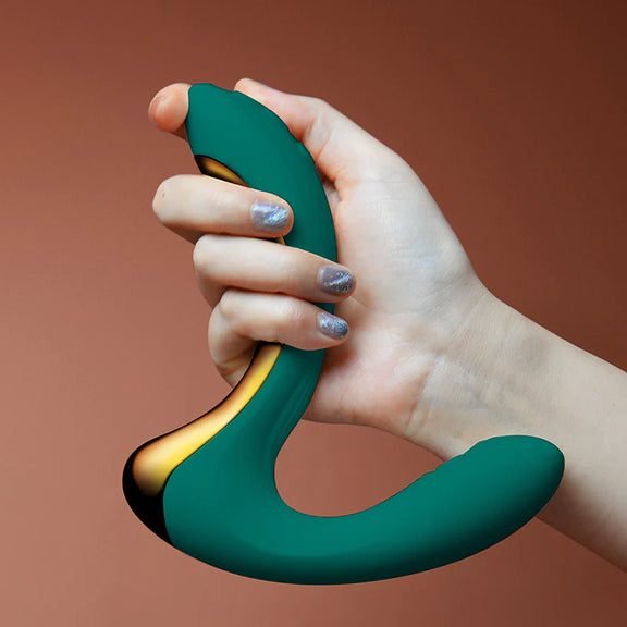A hand holds the handle of the Zalo Talis. It's a 90-degree design that's more ergonomic than standard g-spot toys. | Kinkly Shop