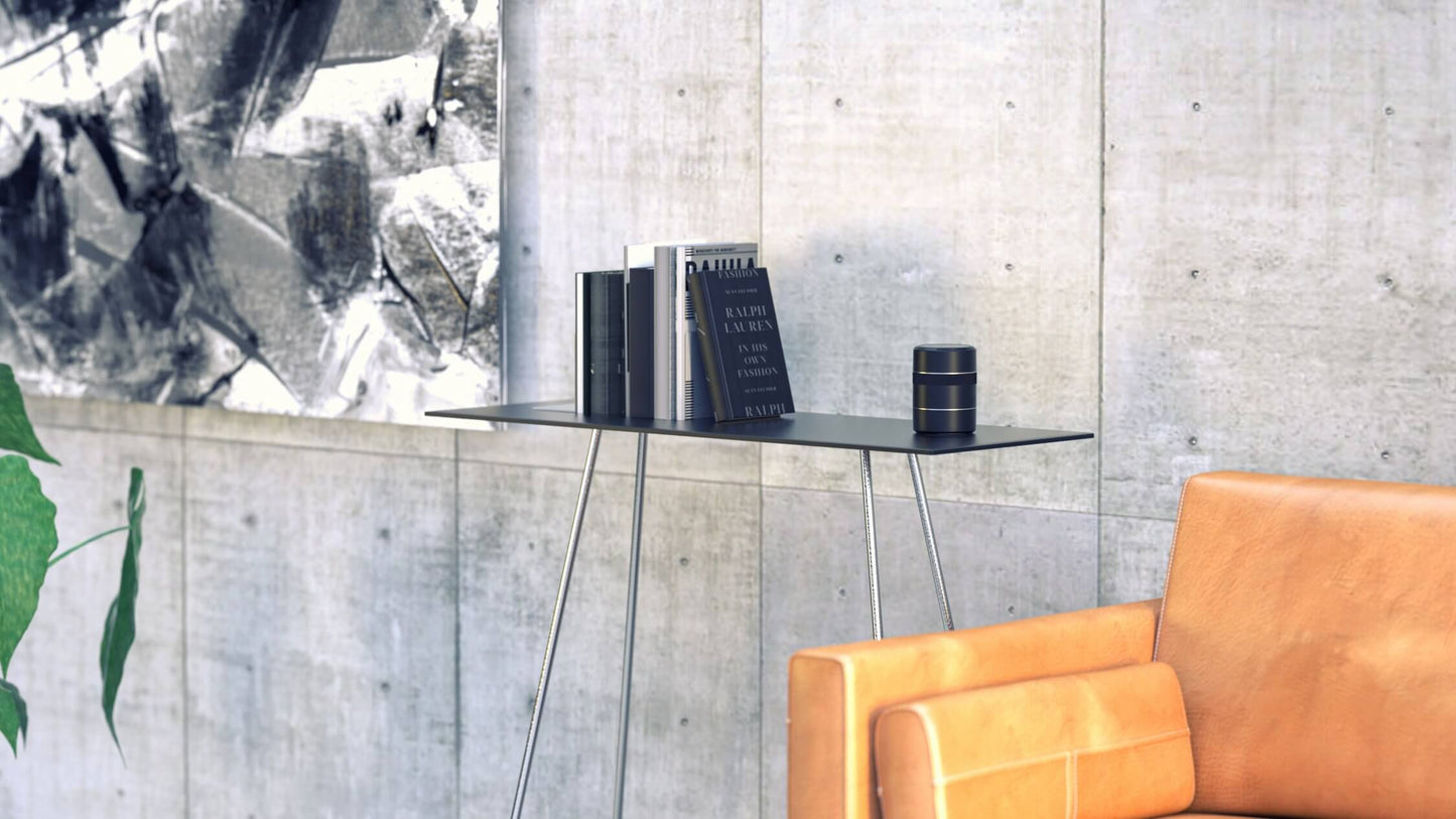 The Arcwave Voy sits out on a shelf next to a shelf of books. The Arcwave Voy looks entirely discreet and like it fits into the decor of the home. It does not look like a sex toy. | Kinkly Shop