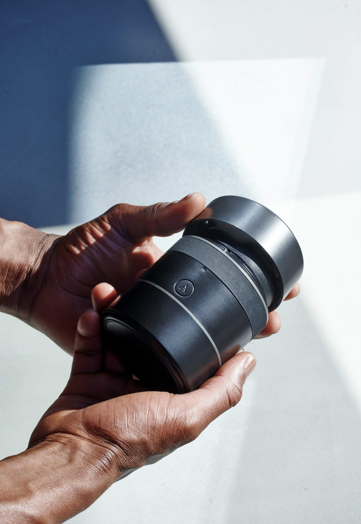 Two hands grasp the Arcwave Voy. One hand is holding the Voy while the opposing hand is removing one of the protector lids from the stroker. | Kinkly Shop