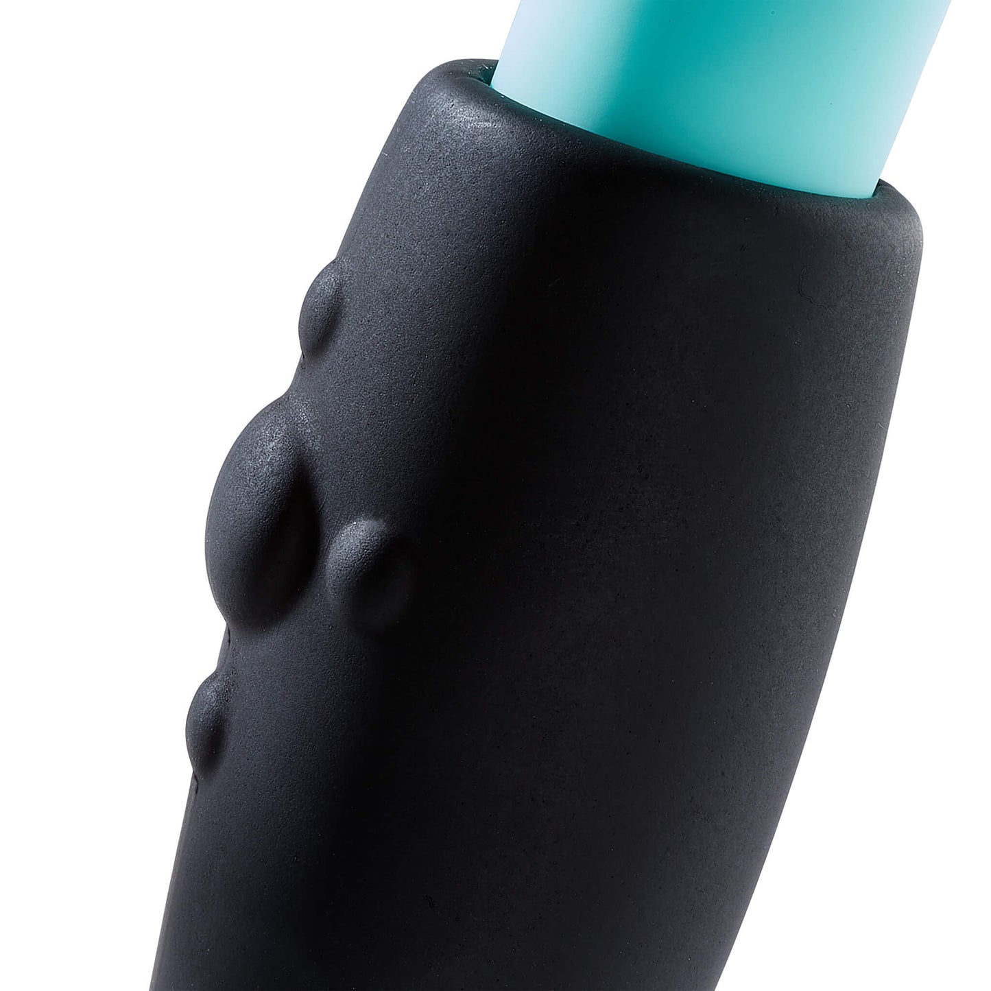 Close-up of the texture on the part of the silicone sheath of the Cloud 9 Rocker Prostate Stimulator that touches the perineum. The image shows one large, bubble-like texture in the center. Four smaller, circular bubbles are placed at the 12, 3, 6, and 9 positions around the largest bubble. | Kinkly Shop