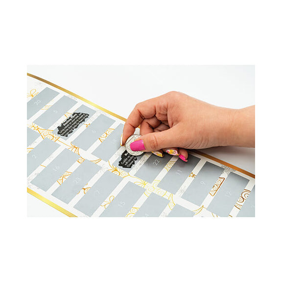 A hand is using a coin to scratch off one of the dares. (Day 8) Another challenge's day is already scratched off. | Kinkly Shop