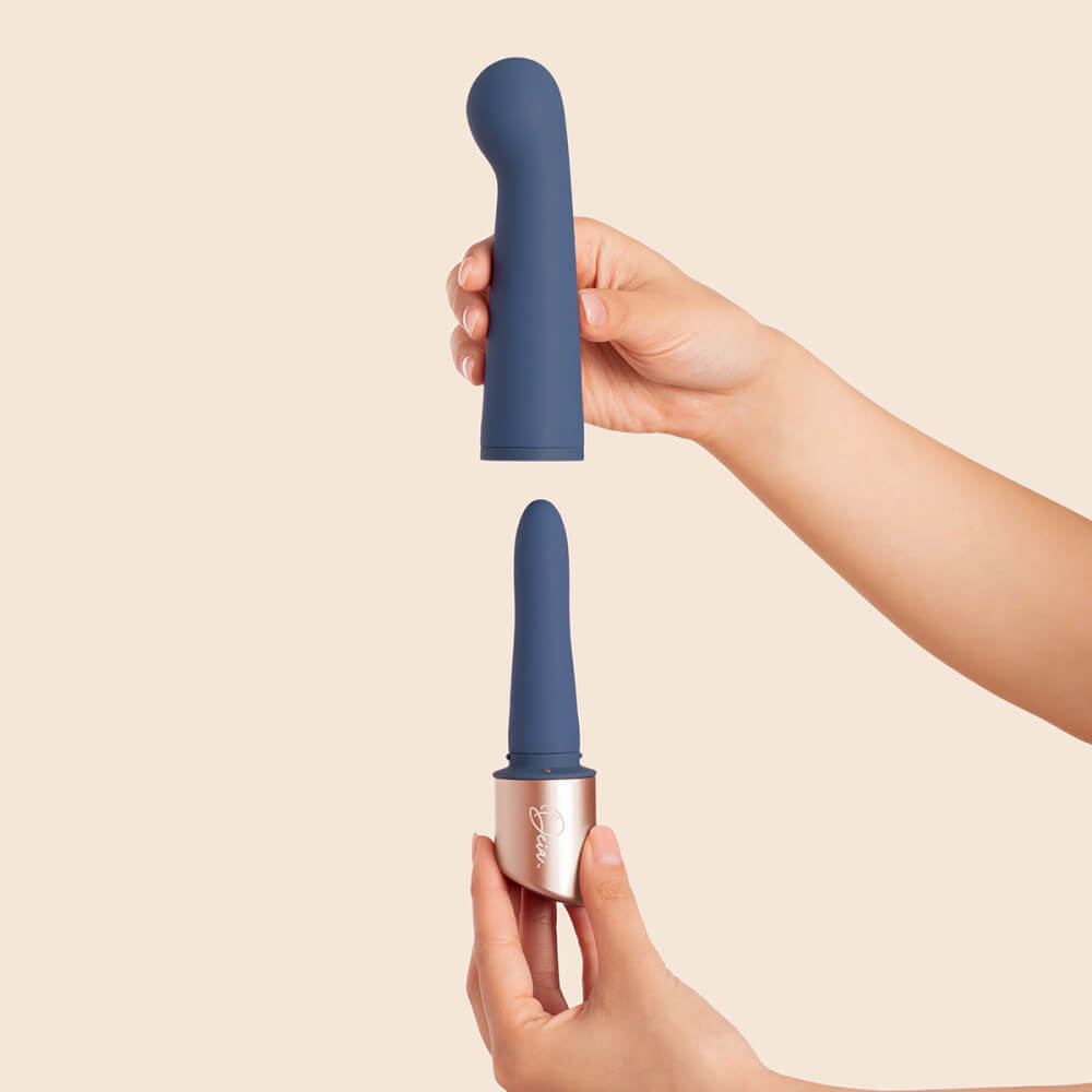 A person's two hands with the Deia The Couple interchangeable tip vibrator. One hand holds the base of the vibrator with the slim, anal-friendly vibe. The other hand is holding the g-spot sleeve that fits on top of the base. | Kinkly Shop