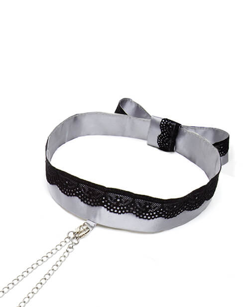 Close-up of the "Play Nice" Satin Collar with Nipple Clamps. This angle showcases the lace detailing along the collar. It also shows where the two nipple clamp chains fasten onto a loop of satin on the collar. | Kinkly Shop