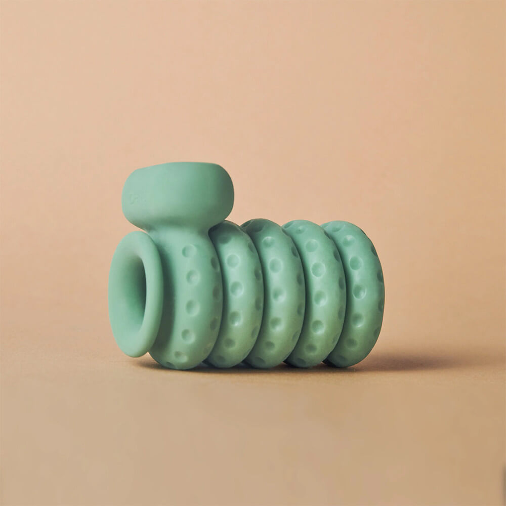 A full set of original OhNut are shown with the OhNut Vibrating Ring in Wide. All of the rings interlock together into one, cohesive penetration buffer. The vibrator of the OhNut Vibrating Ring protrudes away from the stack of rings, but it's clearly built into the material of the OhNut Vibrating Ring itself. | Kinkly Shop