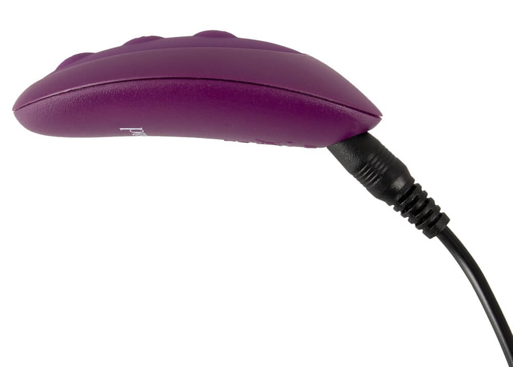 Close-up of the Orion VibePad 2 remote plugged into the USB cord for recharging. | Kinkly Shop