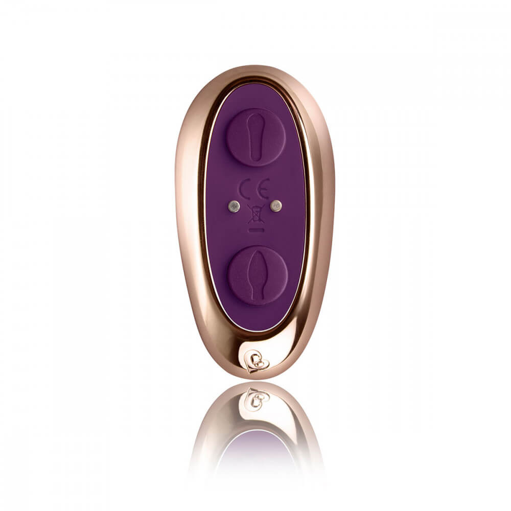 Close-up of the Rocks-Off Cocktail remote. This showcases the two separate buttons on the remote. Each button controls one of the two motors. In the middle of the buttons, there are two magnetic contact points that function as the charging point for this vibrator remote. | Kinkly Shop