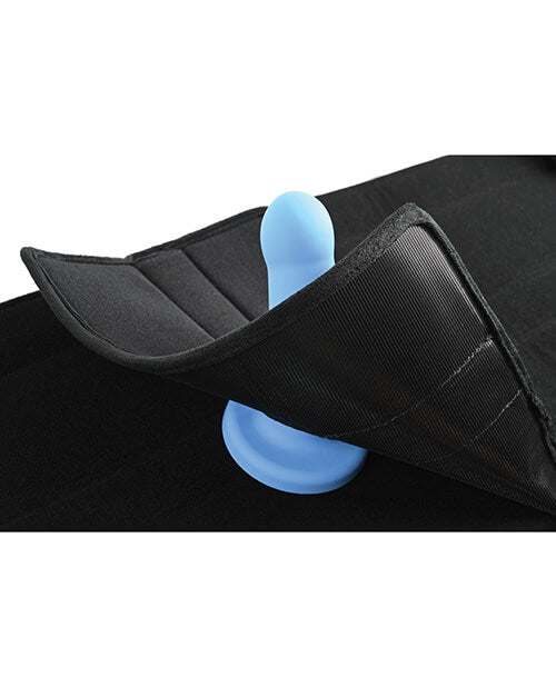 Showing how the dildo pad works. A dildo is placed on the seat of the Sportsheets Door Jam Sex Sling Special Edition plus size sex swing while the dildo pad is partially adhered to the surface of the seat. This shows how the dildo pad's design helps hold the dildo in place. | Kinkly Shop