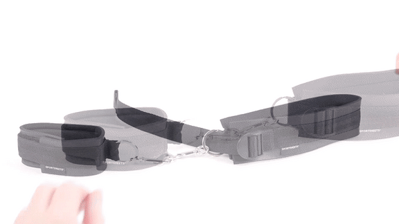 GIF shows the wrist cuff and thigh cuff sitting out together and fastened together. Two hands come in and unclip the cuffs then reclip the cuffs together to show how easily these bondage cuffs come apart. | Kinkly Shop