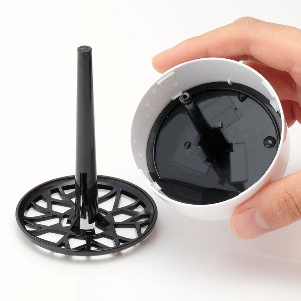 Another angle of the Tenga Aero lid shows how the lid captures all of the excess, dripped off water into the lid while keeping the toy away from the puddle for easy drying. This shows that it will keep water from dripping onto your countertops. | Kinkly Shop