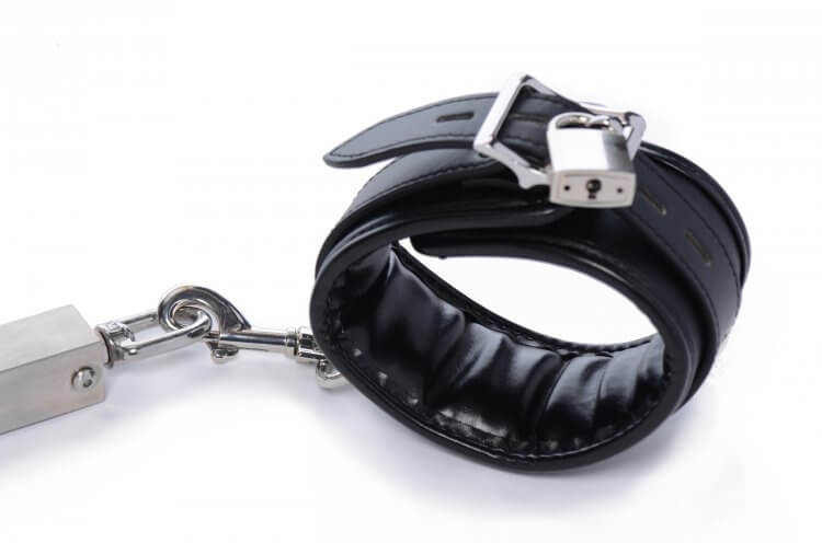 Close-up of the cuffs that come with the Master Series Squat Impaler. This shot shows that the cuffs can be locked on - and also shows that the cuffs attach to the Squat Impaler with a single-sided clip. | Kinkly Shop