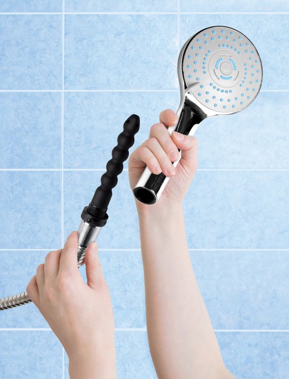 A hand holds the enema bulb and the showerhead that fits overtop of the enema tip to hide it when it's not in use. | Kinkly Shop
