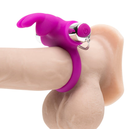 The Happy Rabbit Remote Control Ring wrapped around the base of a dildo, showcasing how the rabbit "nose" and "ears" protrude from the ring to pleasure a nearby partner. | Kinkly Shop